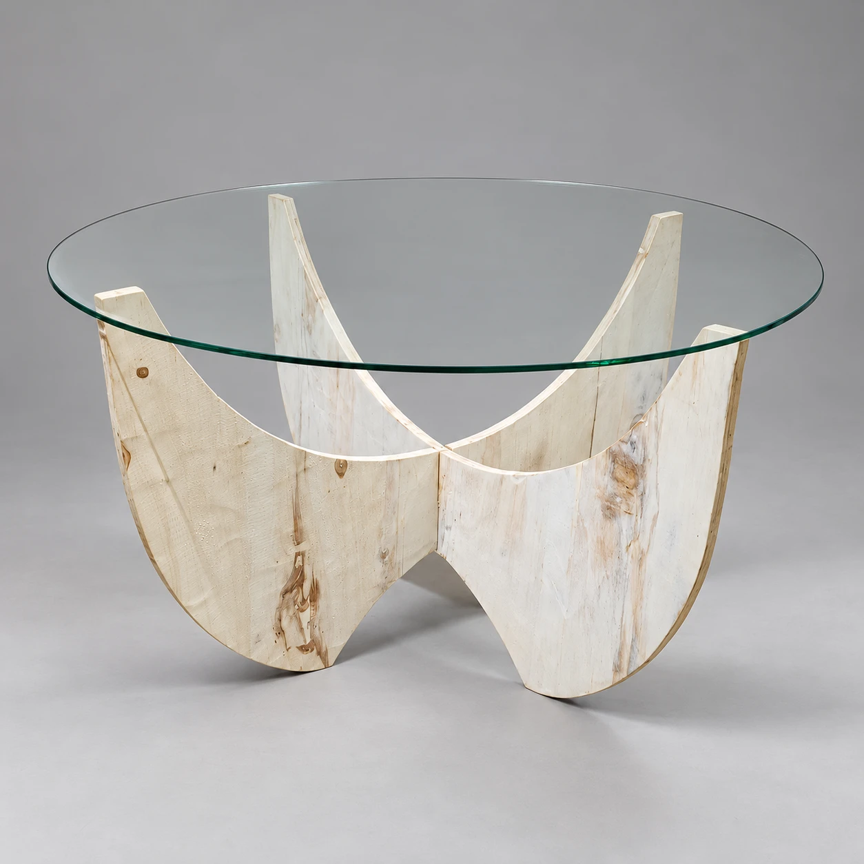 Qhathizwe circular clear-glass table with a pale whitewashed curved cross-panel wooden base